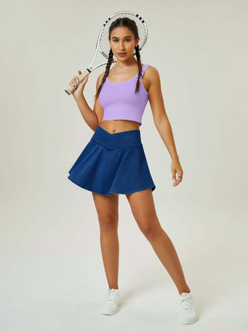 Woman in Funuca High Waist Sports Denim Skirt with cross over V waist, tennis pose